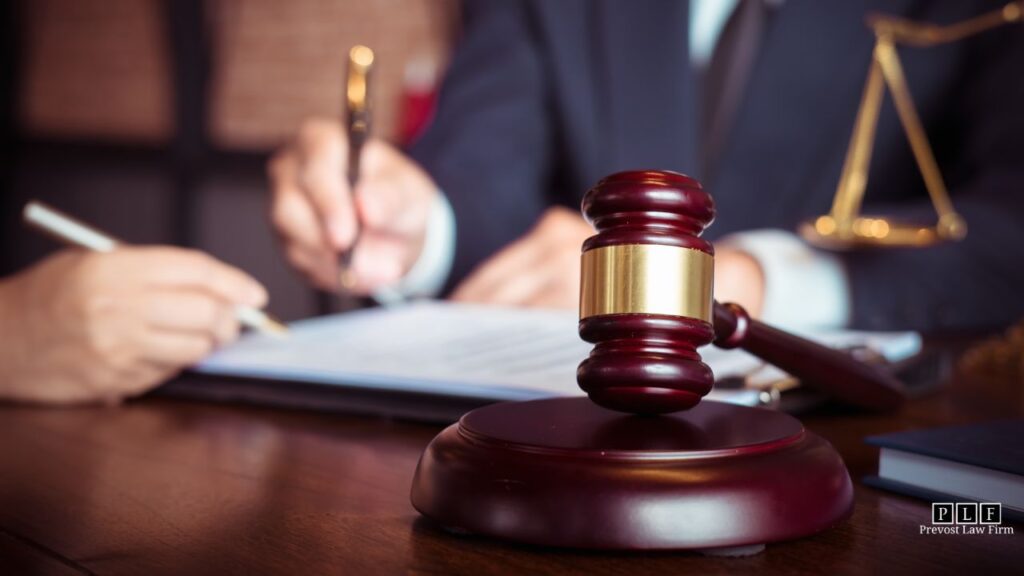 Foreground is a gavel, background is a solar panel lawyer signing documents with a client.