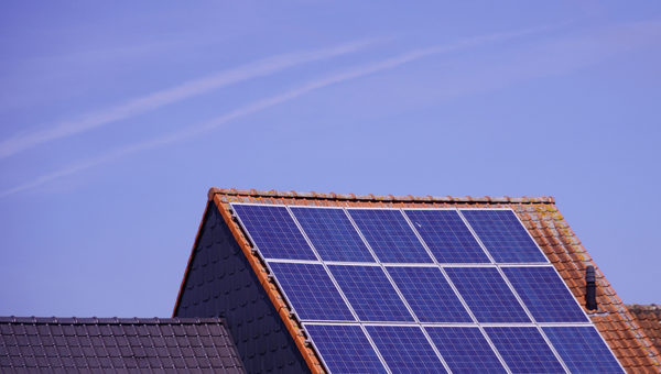 photo of sky with top of a roof with solar panels on it for blog psot Southern Solar Power and the SolaTrue Takeover: What It Means for Homeowners