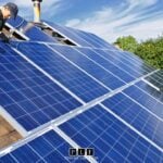 Worker installing solar panels for a solar leasing project.